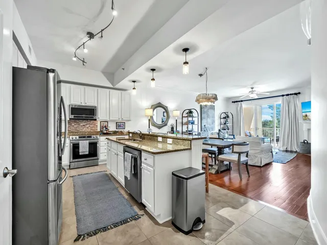 a kitchen with lots of counter top space and stainless steel appliances
