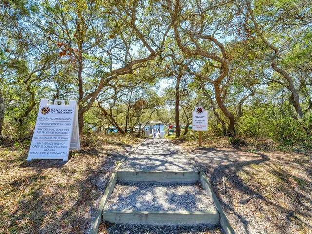 a view of a swimming pool and lounge chairs