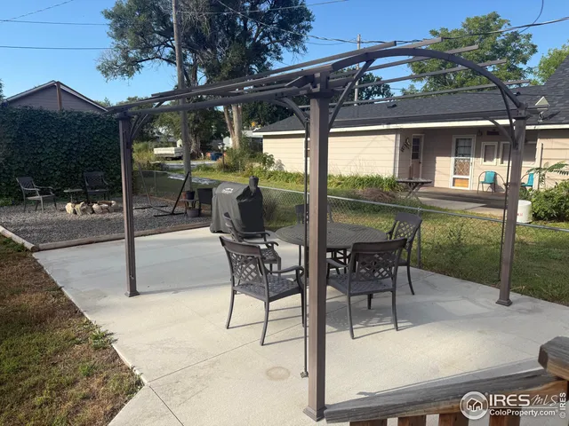 a patio with yard glass top table and chairs