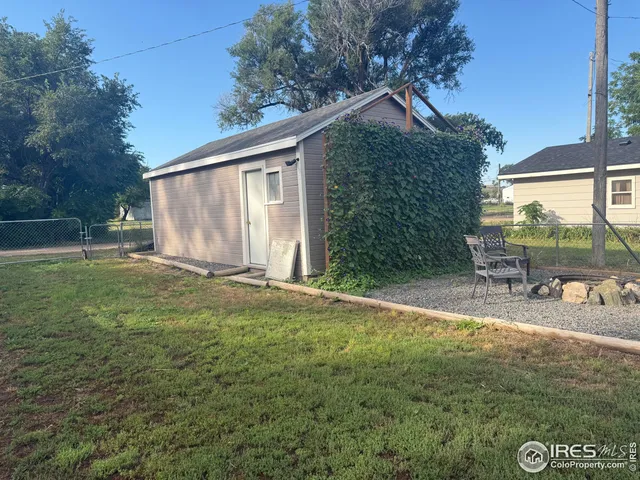 a view of a house with backyard and sitting area