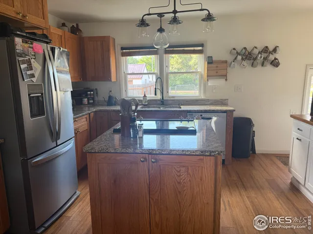 a kitchen with stainless steel appliances granite countertop a refrigerator and a stove