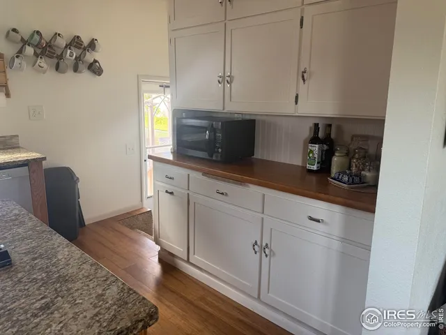 a kitchen with stainless steel appliances white cabinets and a sink