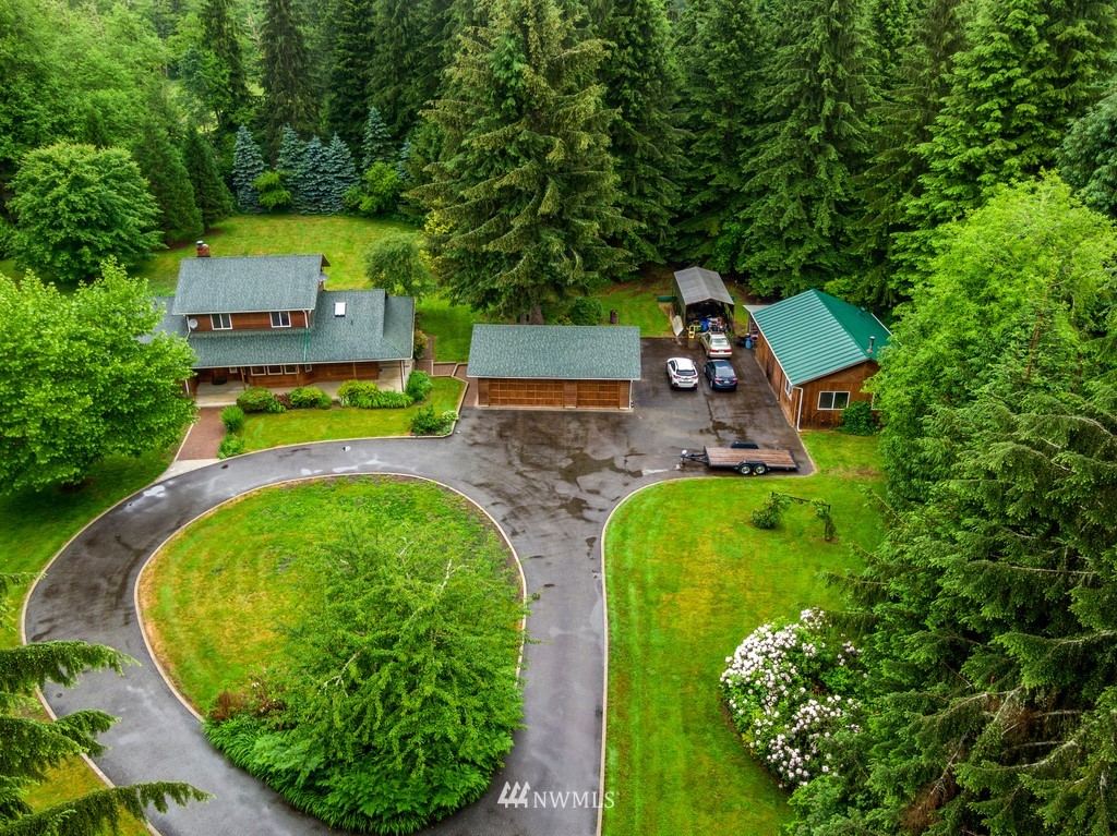 an aerial view of a house with a garden and trees