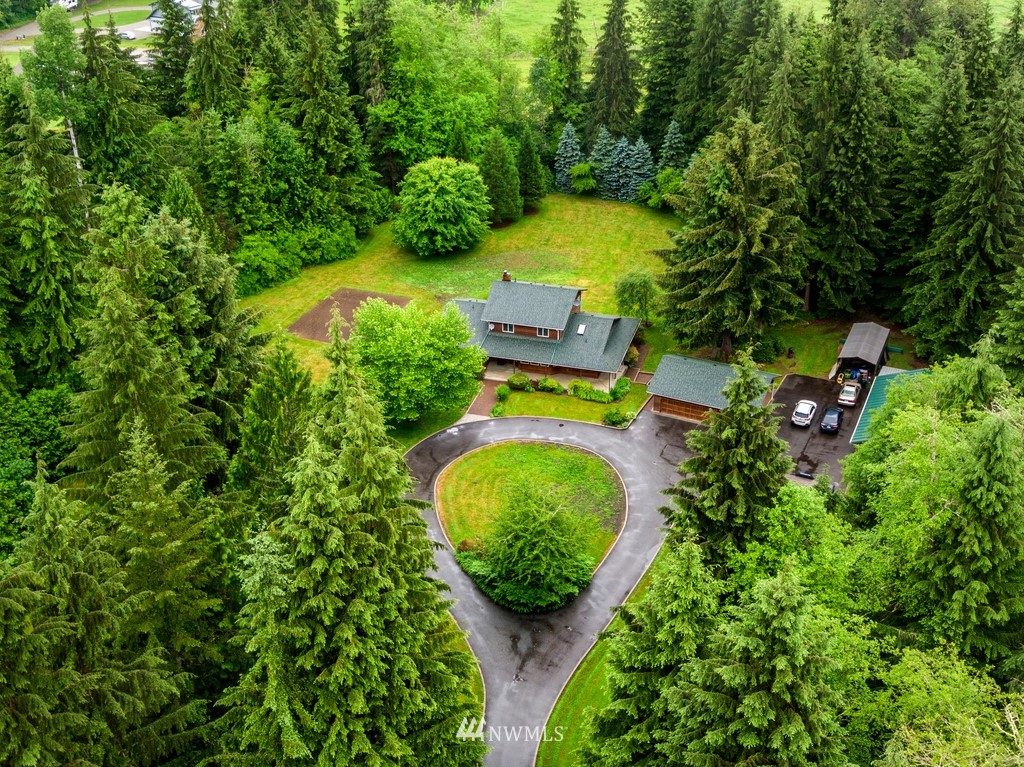 23402 Wallitner Road Arlington, WA 98223 - Photo 11 of 39 an aerial view of a house with a swimming pool a yard and lake view