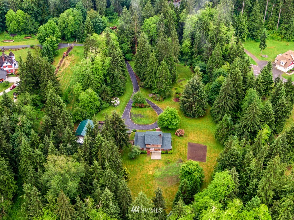 23402 Wallitner Road Arlington, WA 98223 - Photo 12 of 39 an aerial view of a house with swimming pool and garden space