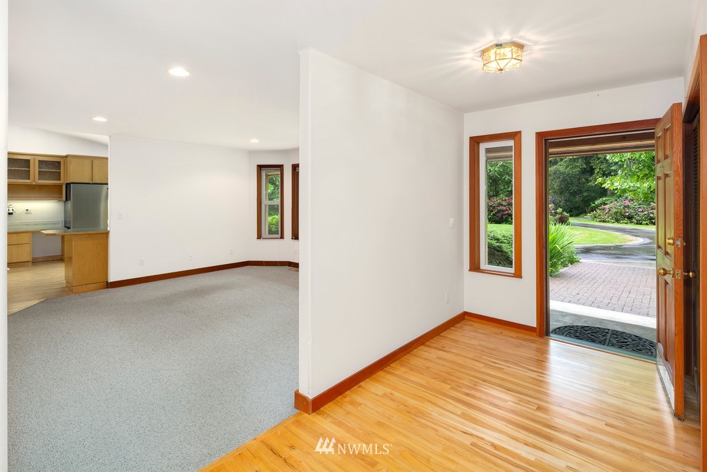 23402 Wallitner Road Arlington, WA 98223 - Photo 16 of 39 a view of an empty room with wooden floor and a window