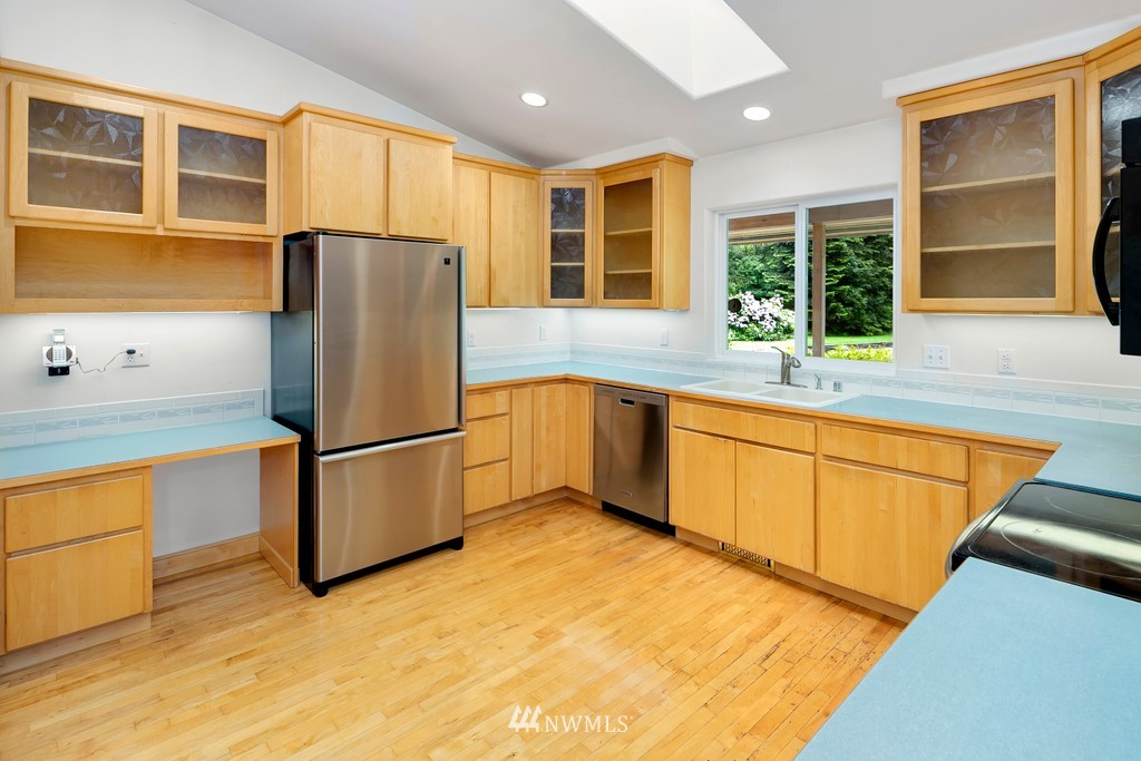 23402 Wallitner Road Arlington, WA 98223 - Photo 19 of 39 a kitchen with stainless steel appliances granite countertop a refrigerator sink and cabinets