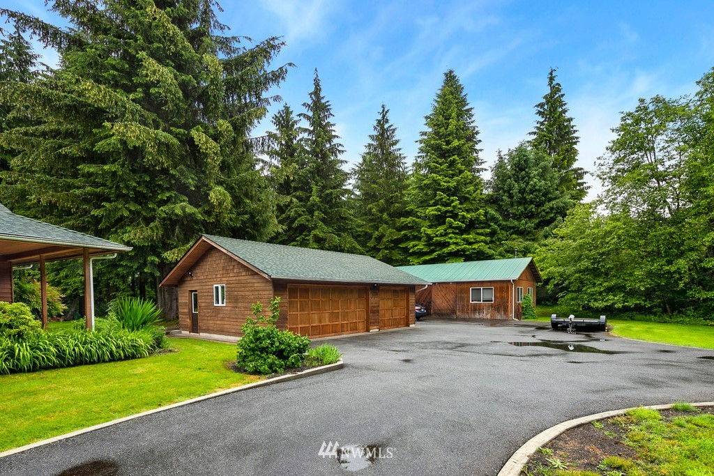 23402 Wallitner Road Arlington, WA 98223 - Photo 3 of 39 a front view of a house with a yard and garage