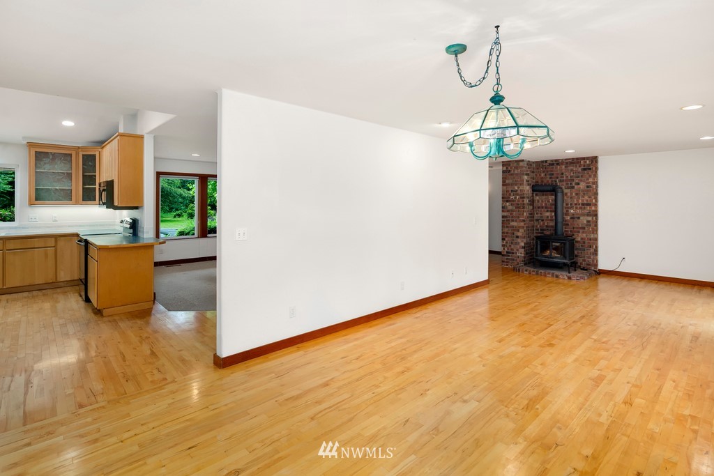 23402 Wallitner Road Arlington, WA 98223 - Photo 22 of 39 a view of an empty room with window and wooden floor