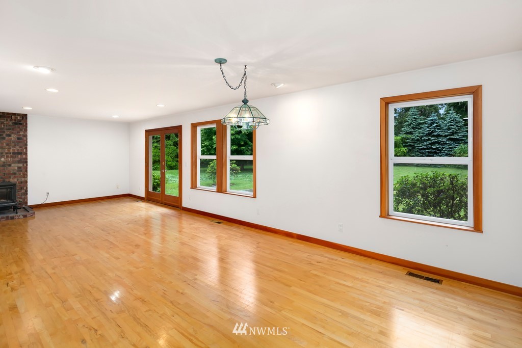 23402 Wallitner Road Arlington, WA 98223 - Photo 23 of 39 a view of an empty room with wooden floor and a window