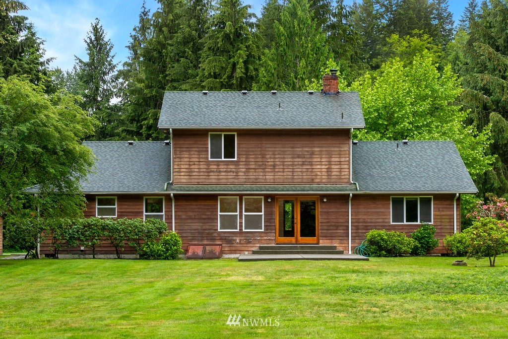 23402 Wallitner Road Arlington, WA 98223 - Photo 6 of 39 a front view of a house with a garden