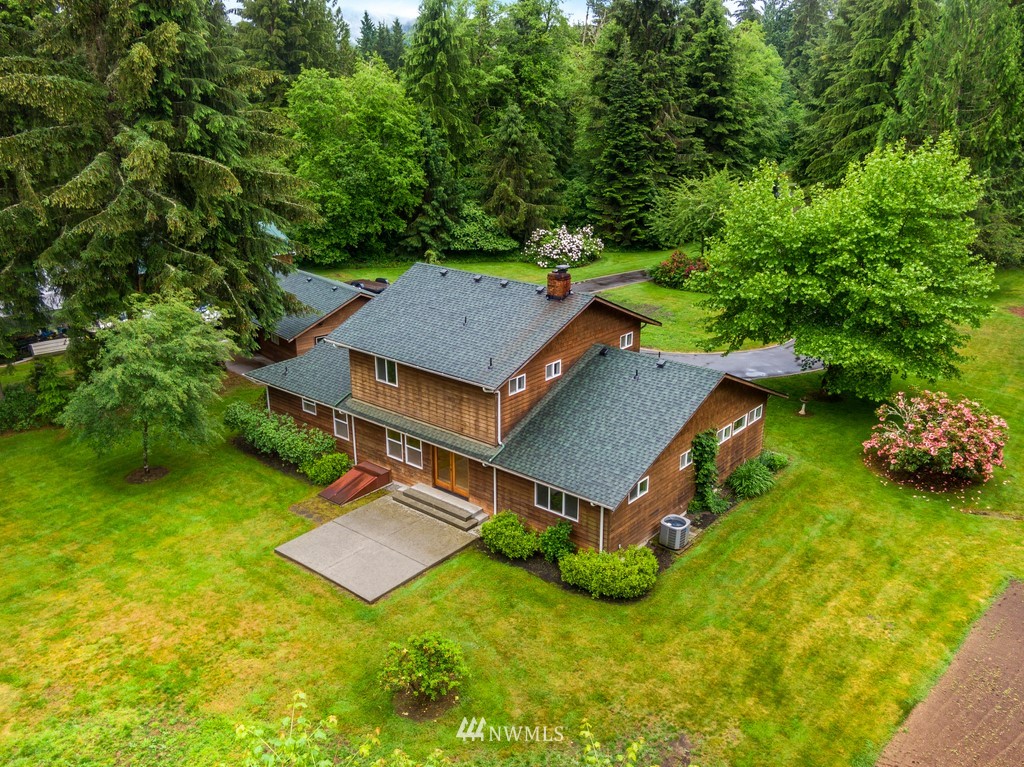 23402 Wallitner Road Arlington, WA 98223 - Photo 9 of 39 an aerial view of a house with swimming pool and garden