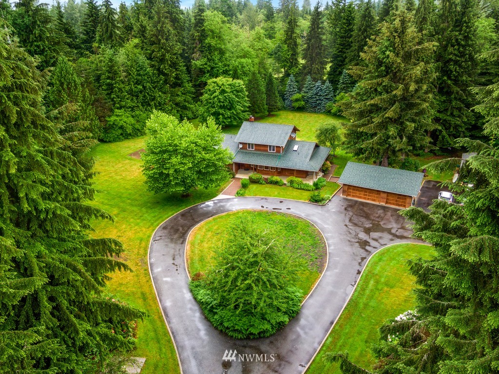 23402 Wallitner Road Arlington, WA 98223 - Photo 10 of 39 an aerial view of a house with swimming pool a yard and a fountain