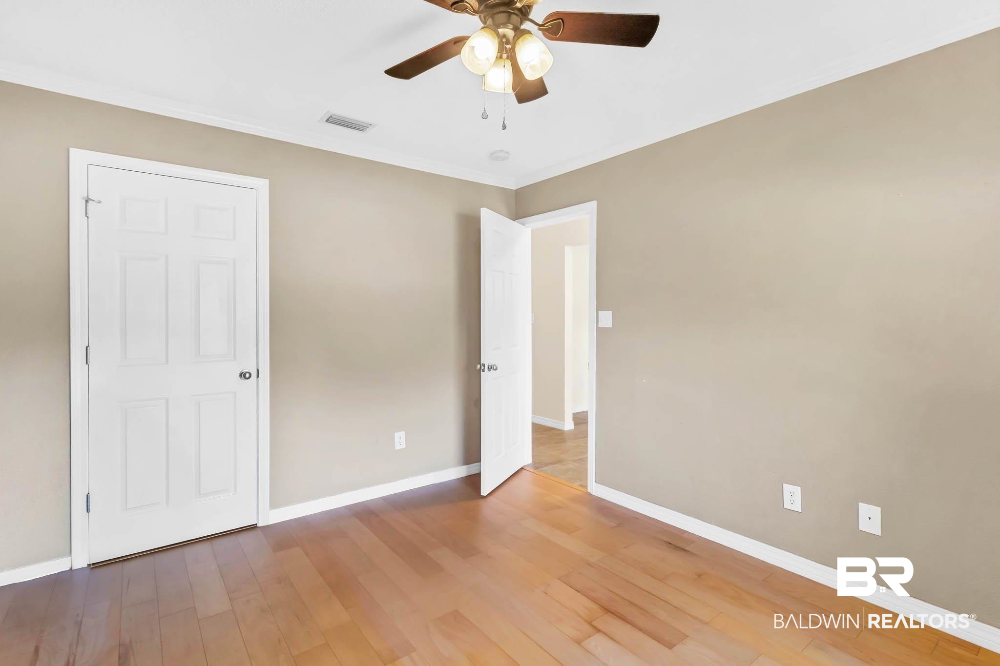 9607 Czar Court Fairhope, AL 36532 - Photo 28 of 42 Unfurnished bedroom featuring light wood-type flooring, crown molding, and ceiling fan