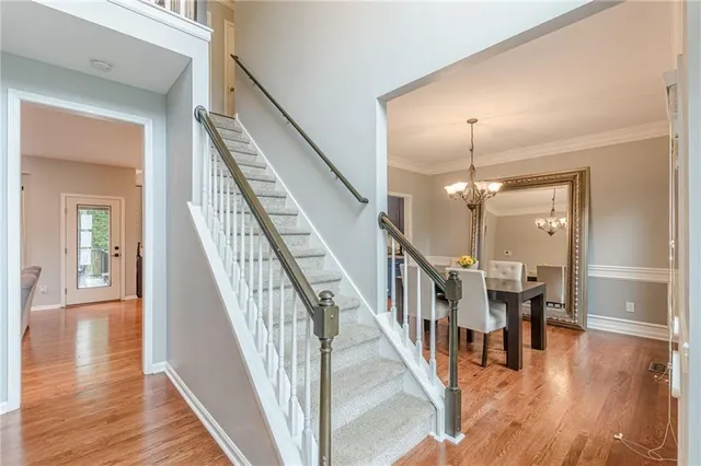 a view of an entryway wooden floor and dining room view