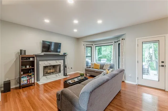 a large kitchen with kitchen island granite countertop a large window and stainless steel appliances