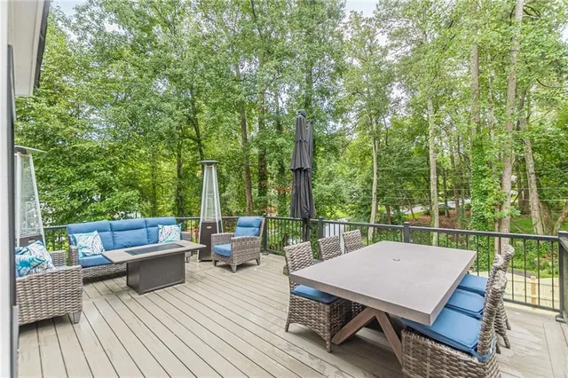 a kitchen with a stove a sink and wooden floor