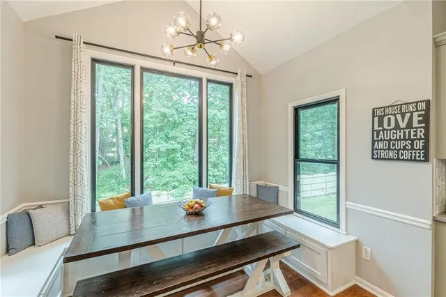 a view of a dining room with furniture and wooden floor