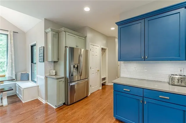 a view of a hallway with wooden floor and entryway