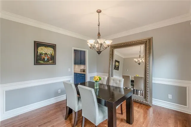 a bedroom with a bed a television and a large window