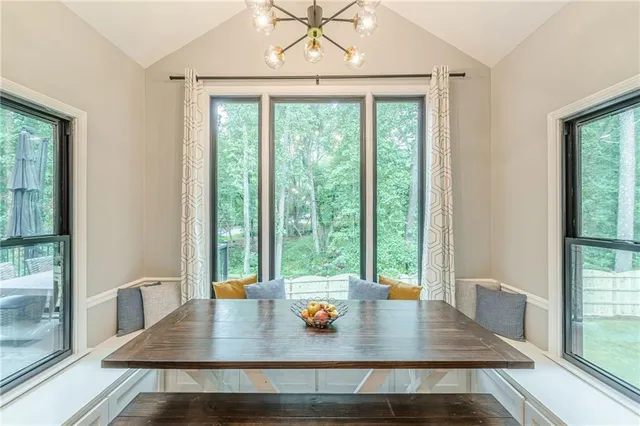 a view of a dining room with furniture window and outside view