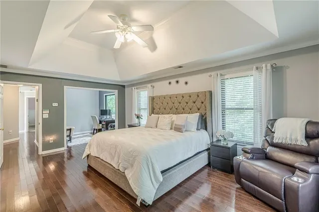 a bedroom with a large bed couch and a window