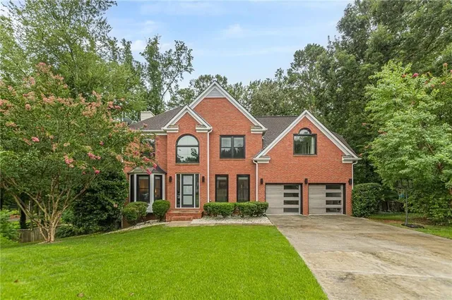 front view of a house next to a yard