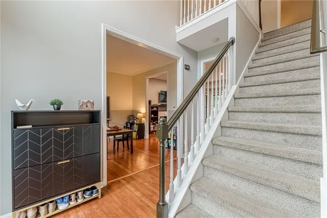 a view of entryway and hall with wooden floor