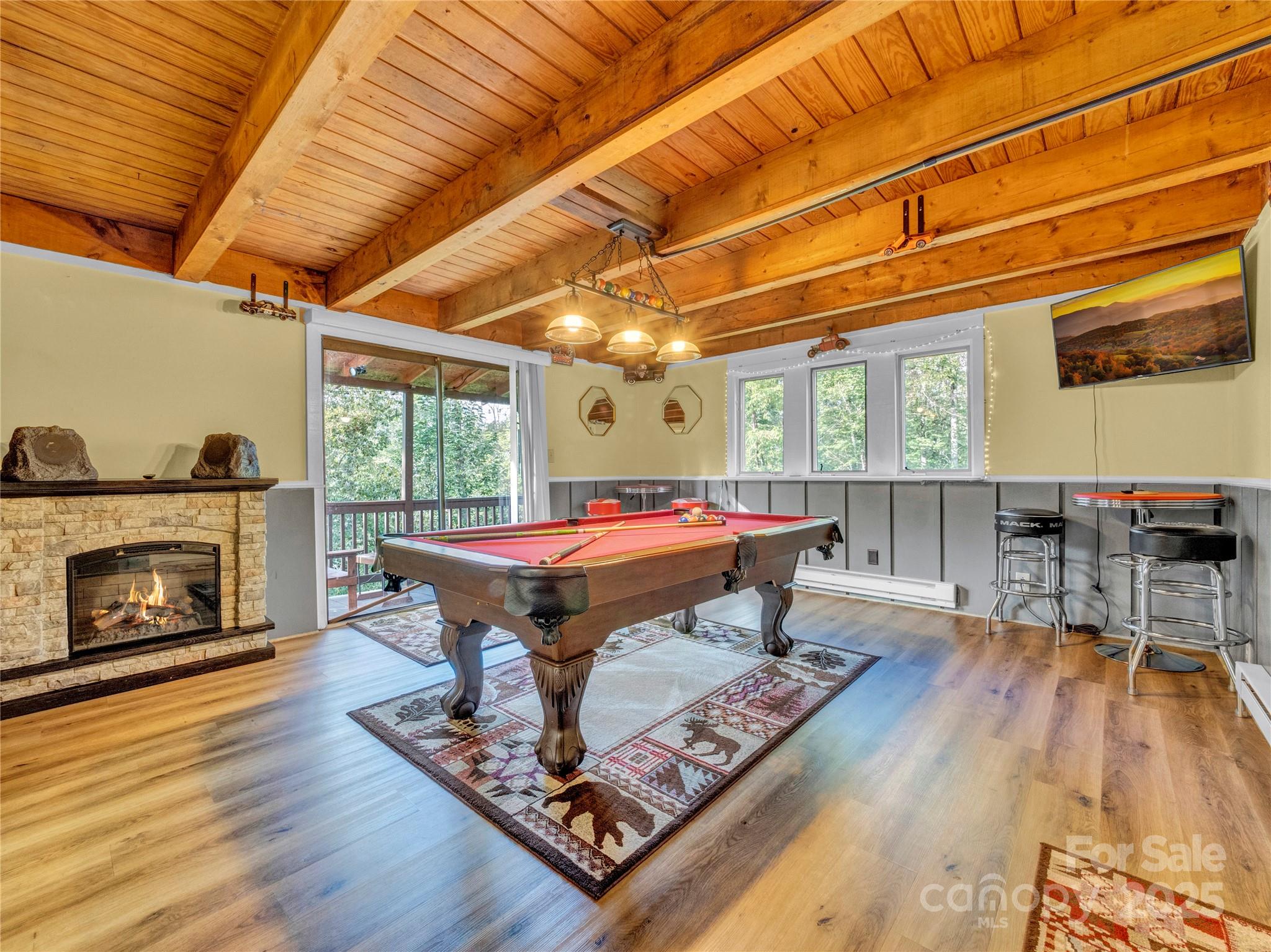 5349 Hickory Nut Gap Road Newland, NC 28657 - Photo 12 of 34 a living room with furniture a fireplace and wooden floor