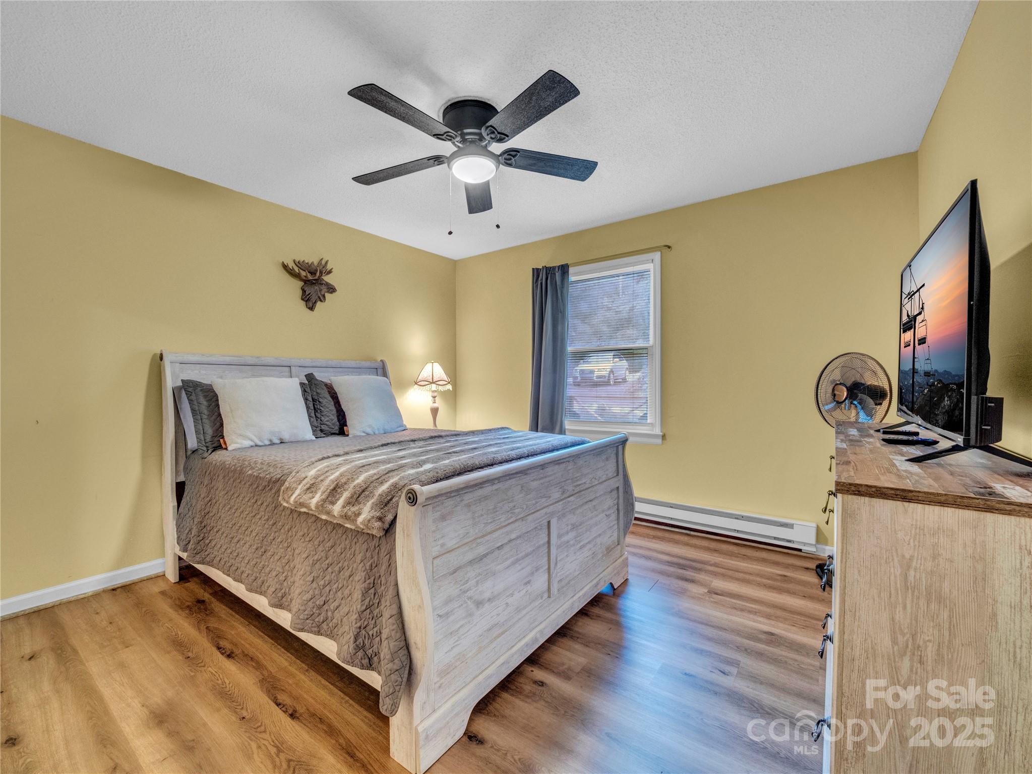 5349 Hickory Nut Gap Road Newland, NC 28657 - Photo 15 of 34 a bedroom with a bed and a flat screen tv
