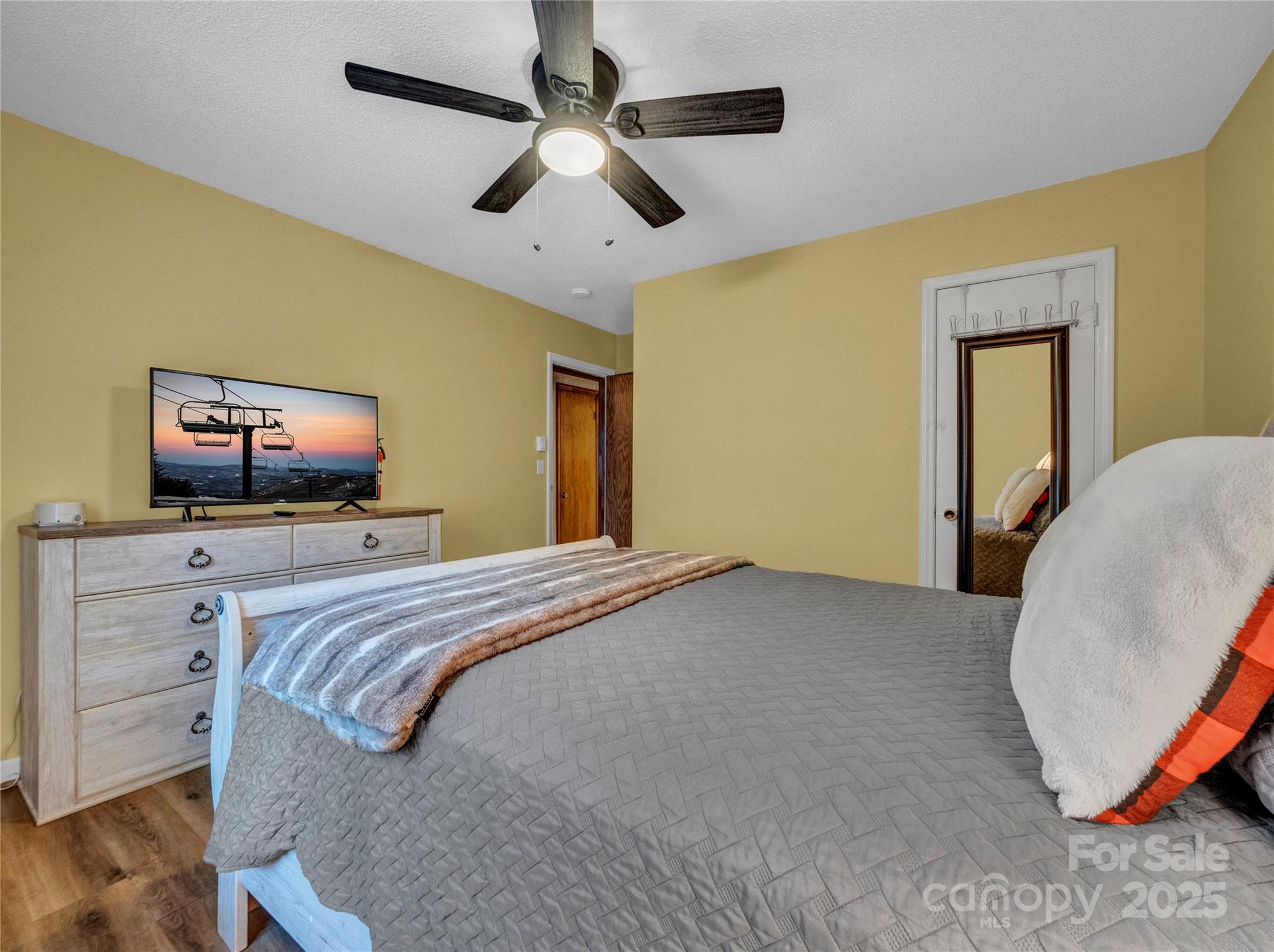 5349 Hickory Nut Gap Road Newland, NC 28657 - Photo 17 of 34 a bedroom with a bed and a flat screen tv