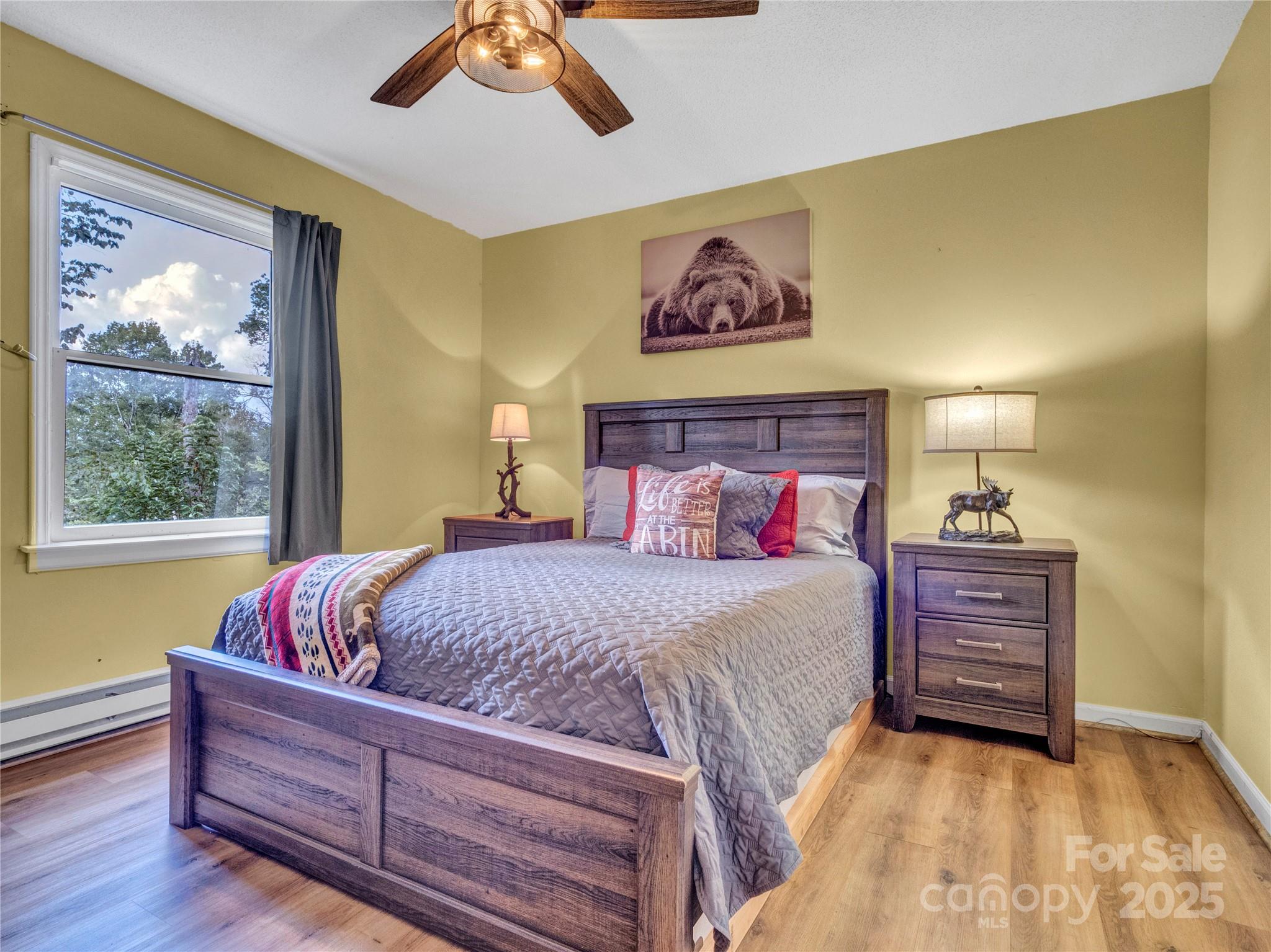 5349 Hickory Nut Gap Road Newland, NC 28657 - Photo 18 of 34 a bedroom with a bed and a painting on the wall