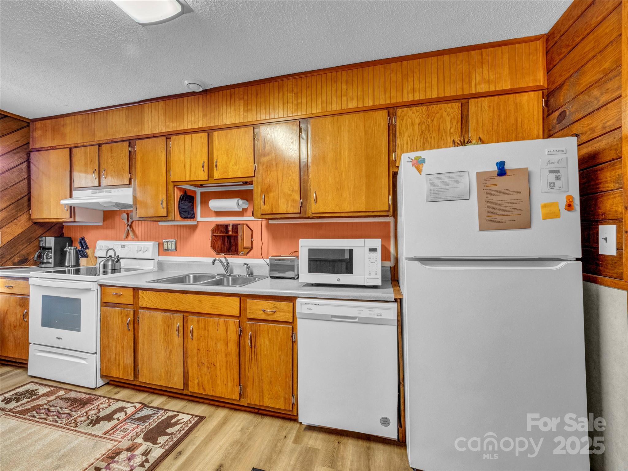 5349 Hickory Nut Gap Road Newland, NC 28657 - Photo 8 of 34 a kitchen with stainless steel appliances granite countertop a refrigerator a sink and a stove