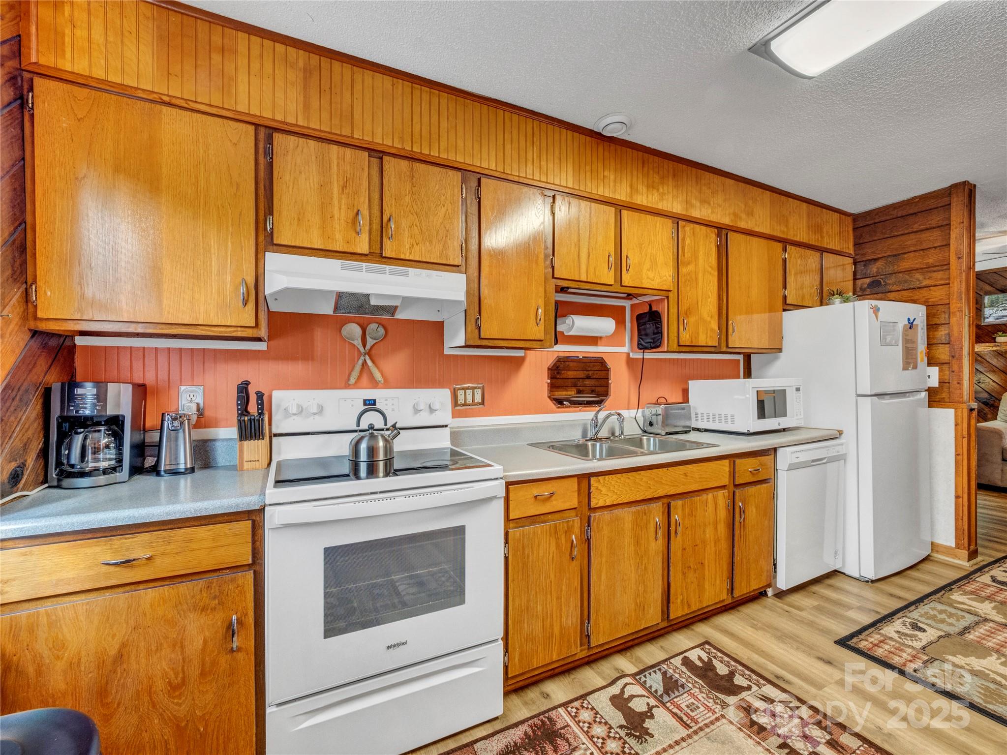 5349 Hickory Nut Gap Road Newland, NC 28657 - Photo 9 of 34 a kitchen with stainless steel appliances granite countertop a sink and cabinets