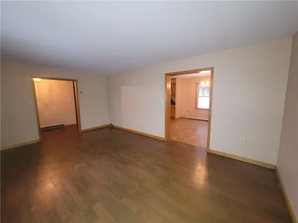 an empty room with wooden floor and closet