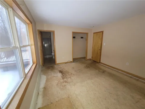 a view of an empty room with glass door