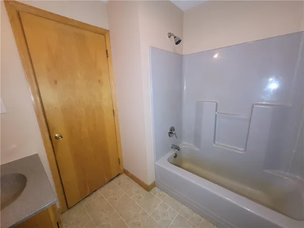 a bathroom with a tub and a sink