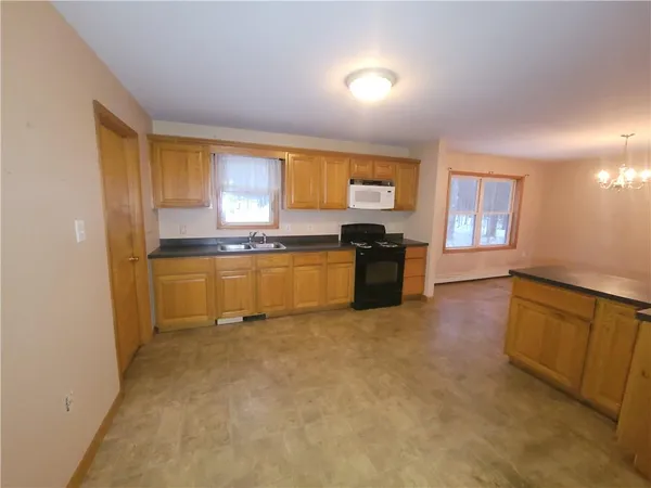a large kitchen with cabinets and a stove top oven