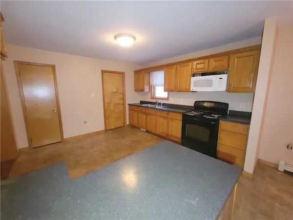 a kitchen with a stove a sink and a refrigerator
