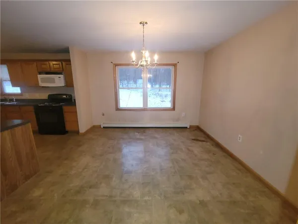 en empty room with windows and furniture