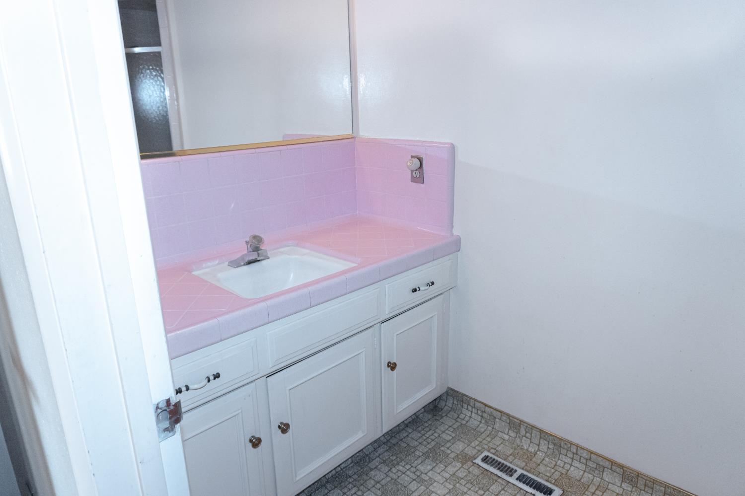 5877 East Dwight Way Fresno, CA 93727 - Photo 17 of 31 a bathroom with a sink and vanity