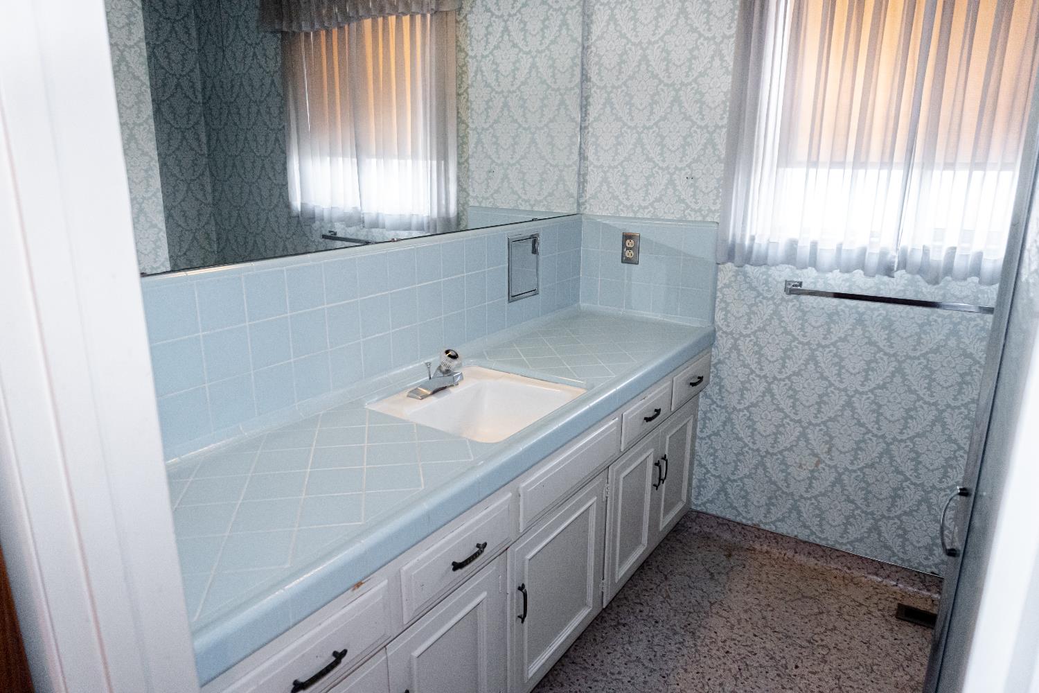 5877 East Dwight Way Fresno, CA 93727 - Photo 19 of 31 a bathroom with a double vanity sink and a window