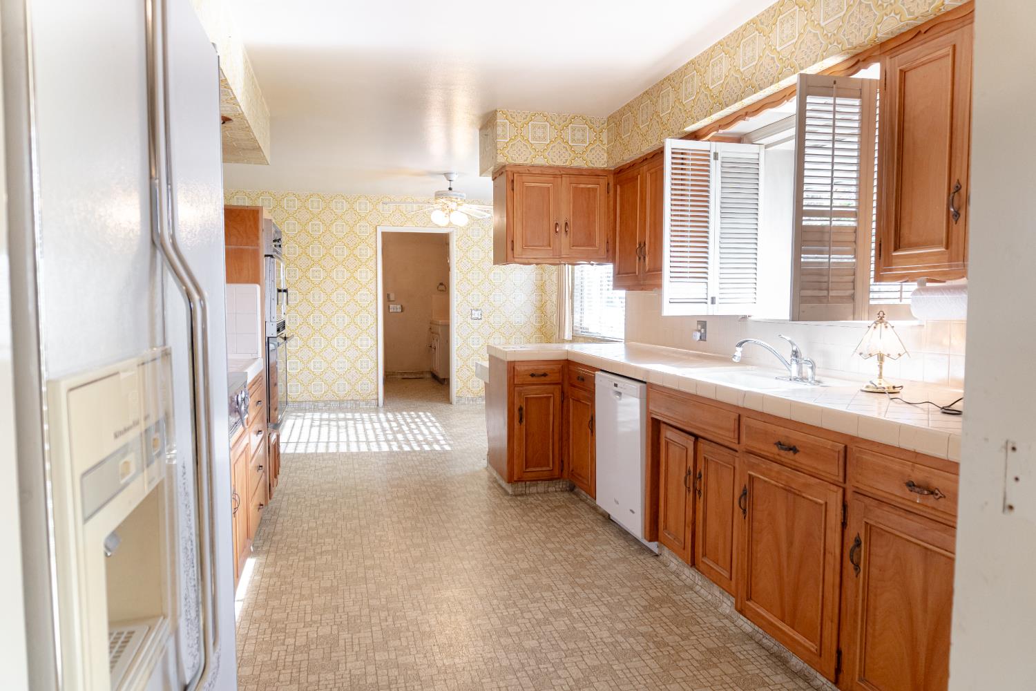 5877 East Dwight Way Fresno, CA 93727 - Photo 3 of 31 a spacious bathroom with a double vanity sink a mirror and a shower