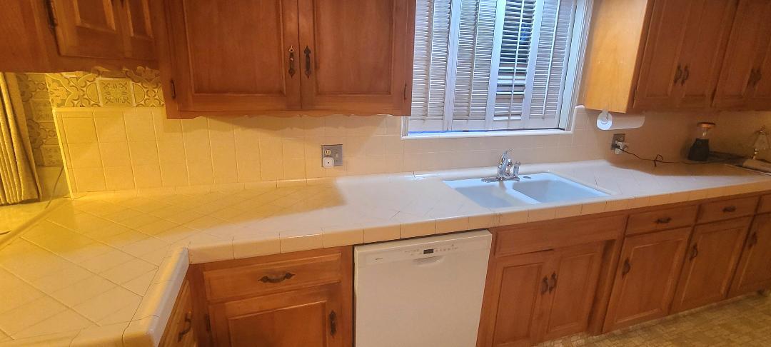 5877 East Dwight Way Fresno, CA 93727 - Photo 5 of 31 a kitchen with a sink and cabinets