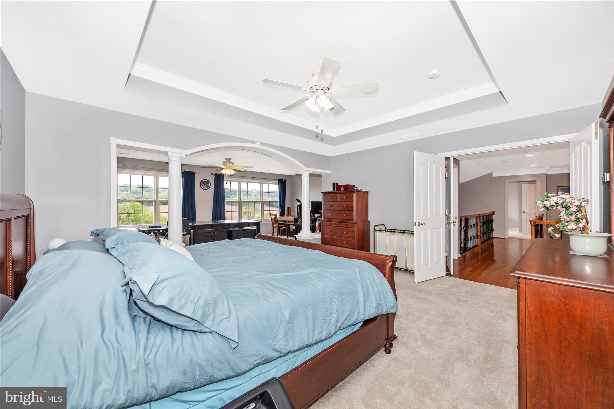 9855 McKinstry Mill Road New Windsor, MD 21776 - Photo 33 of 76 a bedroom with a large bed a flat tv screen and dresser