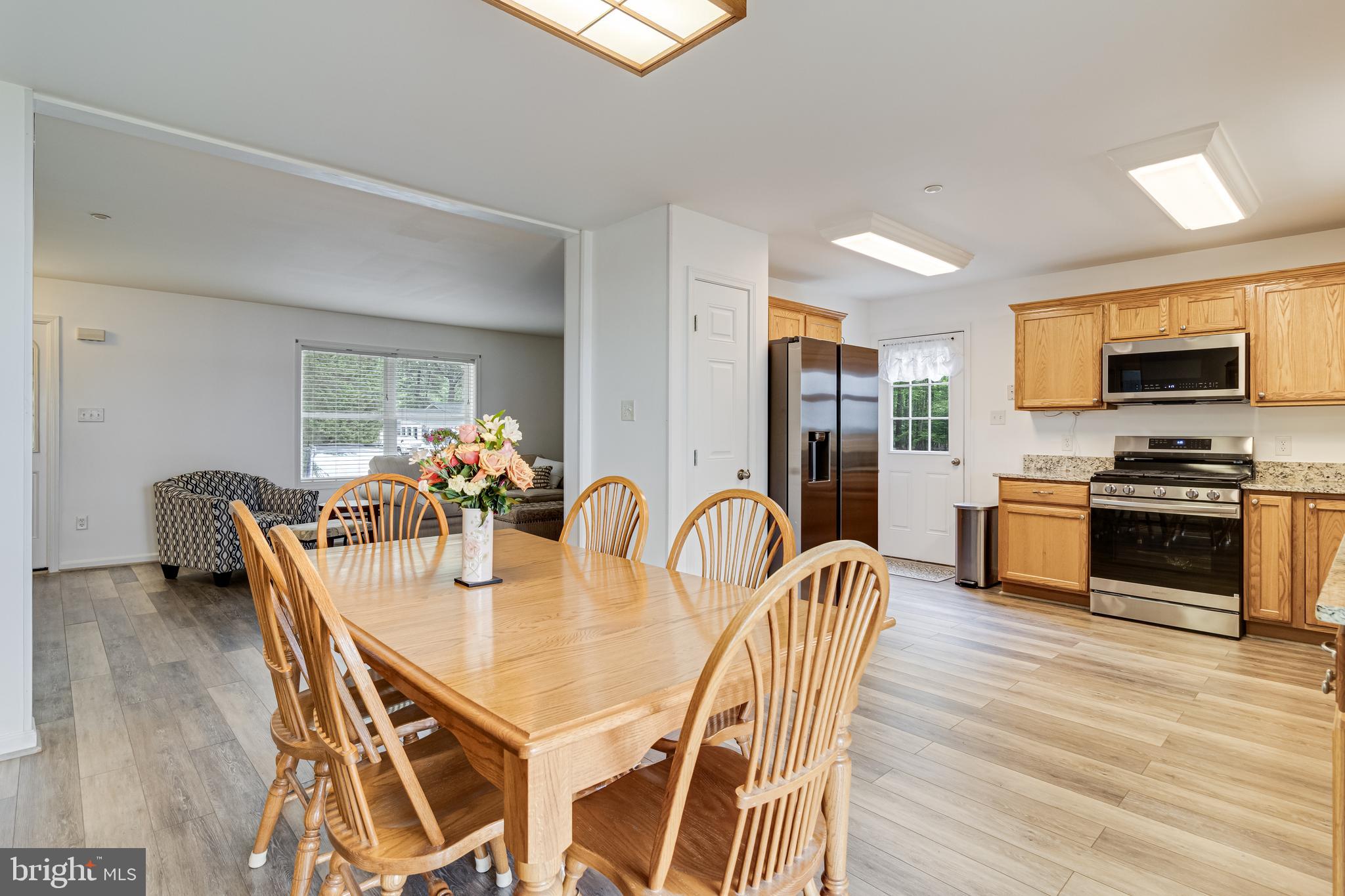 12015 Woodbury Road Nanjemoy, MD 20662 - Photo 33 of 53 a dining room with furniture and wooden floor