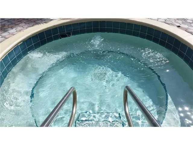 a view of a patio with swimming pool table and chairs