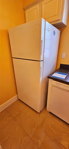 a kitchen with a sink a refrigerator and a stove