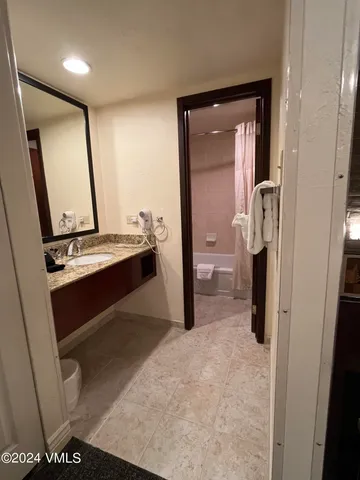 a en suite bathroom with a sink and a mirror