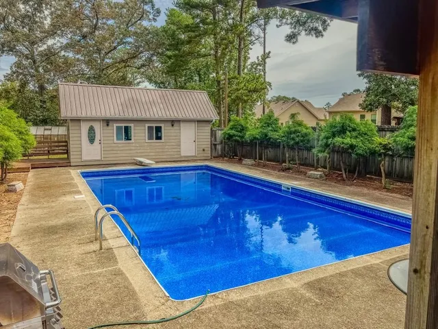 a view of a house with wooden fence